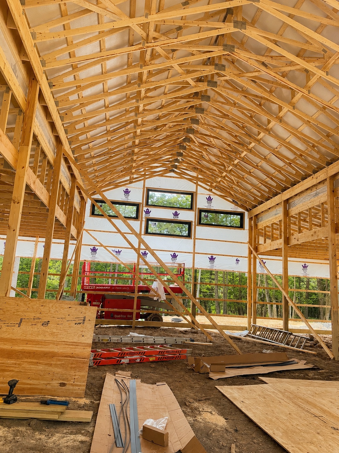 Interior framing and trusses inside a custom post-frame barndominium under construction